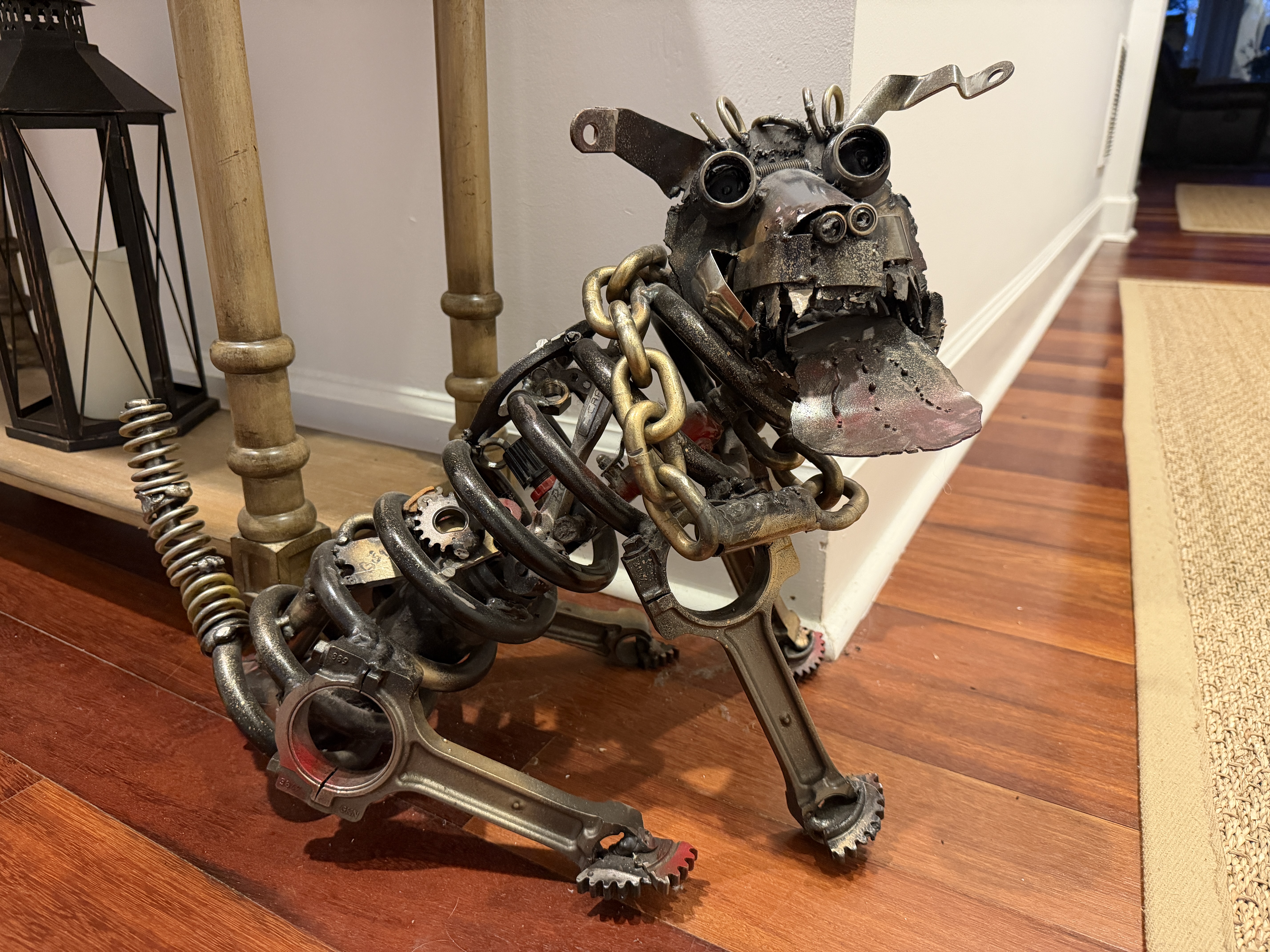 Spot, a metal dog sculpture welded from car springs, motorcycle connecting rods, a chain collar, and sprocket paws.